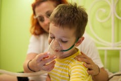 Mother caring kid with aerosols inhalation stock photos Mother caring kid with aerosols inhalation stock photos