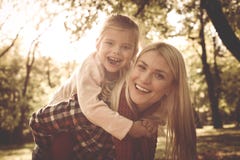 Smiling mother with daughters in park. royalty free stock photography Smiling mother with daughters in park. royalty free stock photography