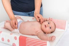 Mother is changing diaper to her little baby stock photography Mother is changing diaper to her little baby stock photography