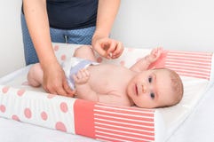 Mother is changing diaper to her little baby stock photo Mother is changing diaper to her little baby stock photo