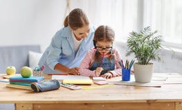 Mother and child daughter doing homework writing and reading at stock photography Mother and child daughter doing homework writing and reading at stock photography