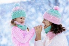 Mother and child in knitted winter hats in snow. stock photography Mother and child in knitted winter hats in snow. stock photography