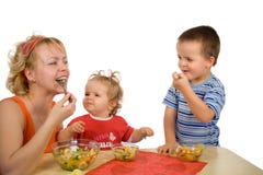 Mother and children eating fruit salad royalty free stock photos Mother and children eating fruit salad royalty free stock photos
