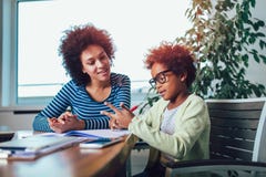 Mother and daughter doing homework learning to calculate stock images Mother and daughter doing homework learning to calculate stock images