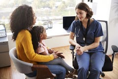 Mother And Daughter Having Consultation With Female Pediatrician Wearing Scrubs In Hospital Office stock photography Mother And Daughter Having Consultation With Female Pediatrician Wearing Scrubs In Hospital Office stock photography