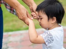 Mother and daughter holding hands walking in the park. Kid and M stock photos Mother and daughter holding hands walking in the park. Kid and M stock photos
