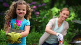 Mother and daughter planting flowers