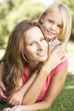 Mother And Daughter Relaxing Together In Park royalty free stock images Mother And Daughter Relaxing Together In Park royalty free stock images