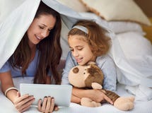 Mother, daughter and tablet in house by bed with movies, video and games online holding teddy bear for mothers day