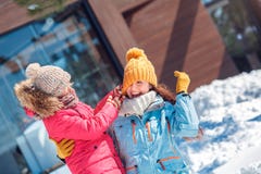 Winter vacation. Family time together outdoors daughter playing with mother taking off her hat laughing cheerful close stock photos Winter vacation. Family time together outdoors daughter playing with mother taking off her hat laughing cheerful close stock photos