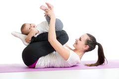Mother doing yoga exercise with baby