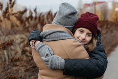 Mother and doughter teenager are walking on the street in warm autumn clothes royalty free stock photo Mother and doughter teenager are walking on the street in warm autumn clothes royalty free stock photo