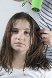Mother drying hair to her daughter stock image Mother drying hair to her daughter stock image