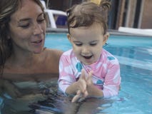 Mother Enjoying A Summer Day On The Swimming Pool with her Family royalty free stock photo Mother Enjoying A Summer Day On The Swimming Pool with her Family royalty free stock photo