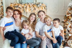 Mother, father and five children near a Christmas tree stock image Mother, father and five children near a Christmas tree stock image