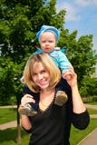 Mother hold child on shoulders outdoor royalty free stock images Mother hold child on shoulders outdoor royalty free stock images
