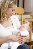 Mother Holding Baby In Nursery royalty free stock photos Mother Holding Baby In Nursery royalty free stock photos