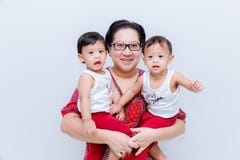 Mother holding two baby Boys. Great happiness, happy young mom with two twins baby. Portrait of young mother holding her little tw royalty free stock images Mother holding two baby Boys. Great happiness, happy young mom with two twins baby. Portrait of young mother holding her little tw royalty free stock images