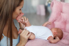 The mother kisses the feet of a newborn son royalty free stock photos The mother kisses the feet of a newborn son royalty free stock photos