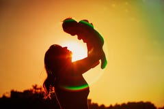 Mother and little baby play at sunset sky royalty free stock images Mother and little baby play at sunset sky royalty free stock images