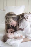 Mother Looking At Baby Boy In Bedroom stock photography Mother Looking At Baby Boy In Bedroom stock photography