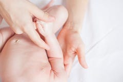 Mother makes nursing baby massage stock photo Mother makes nursing baby massage stock photo
