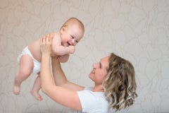 Mother is playing with her baby son in the bedroom stock photos Mother is playing with her baby son in the bedroom stock photos