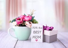 Mother`s day greeting card. Flowers and gift box.