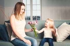 Mother`s Day. Woman And Child With Flowers And Gift Card Stock Images Mother`s Day. Woman And Child With Flowers And Gift Card Stock Images