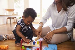 Mother And Son Playing With Toys On Floor At Home royalty free stock photos Mother And Son Playing With Toys On Floor At Home royalty free stock photos