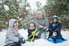 Mother with three children in winter nature. Outdoors in snow