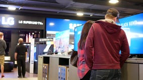 Motion of people looking for a new tv inside Best buy store