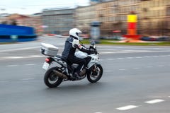 Motorcycle rides with speed on city roads stock photography Motorcycle rides with speed on city roads stock photography