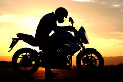 Motorcyclist silhouette at the sunset stock images Motorcyclist silhouette at the sunset stock images