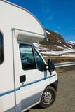 Motorhome / RV at the side of the road in Norway with snowy hills in the background royalty free stock image Motorhome / RV at the side of the road in Norway with snowy hills in the background royalty free stock image