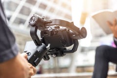 Motorized gimbal, videographer using dslr camera anti shake tool royalty free stock photos Motorized gimbal, videographer using dslr camera anti shake tool royalty free stock photos