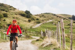 Mountain bike di guida dell'uomo sulla strada campestre Immagini Stock Libere da Diritti Mountain bike di guida dell'uomo sulla strada campestre Immagini Stock Libere da Diritti