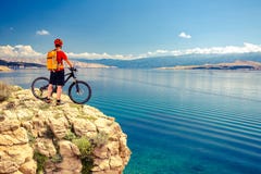 Mountain biker looking at view and riding a bike Stock Images Mountain biker looking at view and riding a bike Stock Images