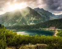Mountain landscape with pond and mountain chalet stock image Mountain landscape with pond and mountain chalet stock image