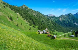 Mountain landscape in summer with characteristic barns in Trentino Alto Adige. View from Passo Rolle, Italian Dolomites, Trento, I Stock Photography Mountain landscape in summer with characteristic barns in Trentino Alto Adige. View from Passo Rolle, Italian Dolomites, Trento, I Stock Photography