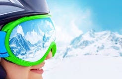 Portrait of young woman at the ski resort on the background of mountains and blue sky.A mountain range reflected in the ski mask royalty free stock photos Portrait of young woman at the ski resort on the background of mountains and blue sky.A mountain range reflected in the ski mask royalty free stock photos