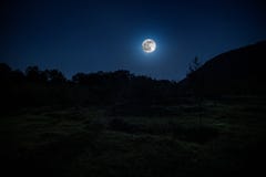 Mountain Road through the forest on a full moon night. Scenic night landscape of dark blue sky with moon. Azerbaijan stock images Mountain Road through the forest on a full moon night. Scenic night landscape of dark blue sky with moon. Azerbaijan stock images