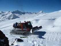 Mountain ratrak carries snowboarders and skiers on the high slope of the mountain royalty free stock photo Mountain ratrak carries snowboarders and skiers on the high slope of the mountain royalty free stock photo