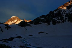Mountain snowy peak illuminated by the setting sun royalty free stock image Mountain snowy peak illuminated by the setting sun royalty free stock image
