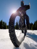 Mountainbiker riding snowy trail in winter. Biker on bike in deep snow Royalty Free Stock Photo Mountainbiker riding snowy trail in winter. Biker on bike in deep snow Royalty Free Stock Photo