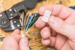 Mounting RJ-45 LAN cable twisted pair connector. Networking Information technology concept. stock photography Mounting RJ-45 LAN cable twisted pair connector. Networking Information technology concept. stock photography