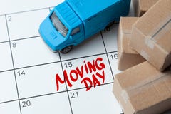 Moving Day On The Calendar Is Written In Red. Calendar With A Note With Cardboard Boxes And Truck. Royalty Free Stock Photos