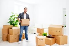 Moving to a new apartment. happy man with cardboard boxes stock photography Moving to a new apartment. happy man with cardboard boxes stock photography