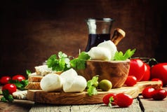 Mozzarella cheese, bread, olives and tomatoes, snack plate. Vintage wooden background, selective focus royalty free stock photo Mozzarella cheese, bread, olives and tomatoes, snack plate. Vintage wooden background, selective focus royalty free stock photo