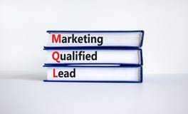 MQL marketing qualified lead symbol. Books with words `MQL marketing qualified lead`. Beautiful white background. Business and M